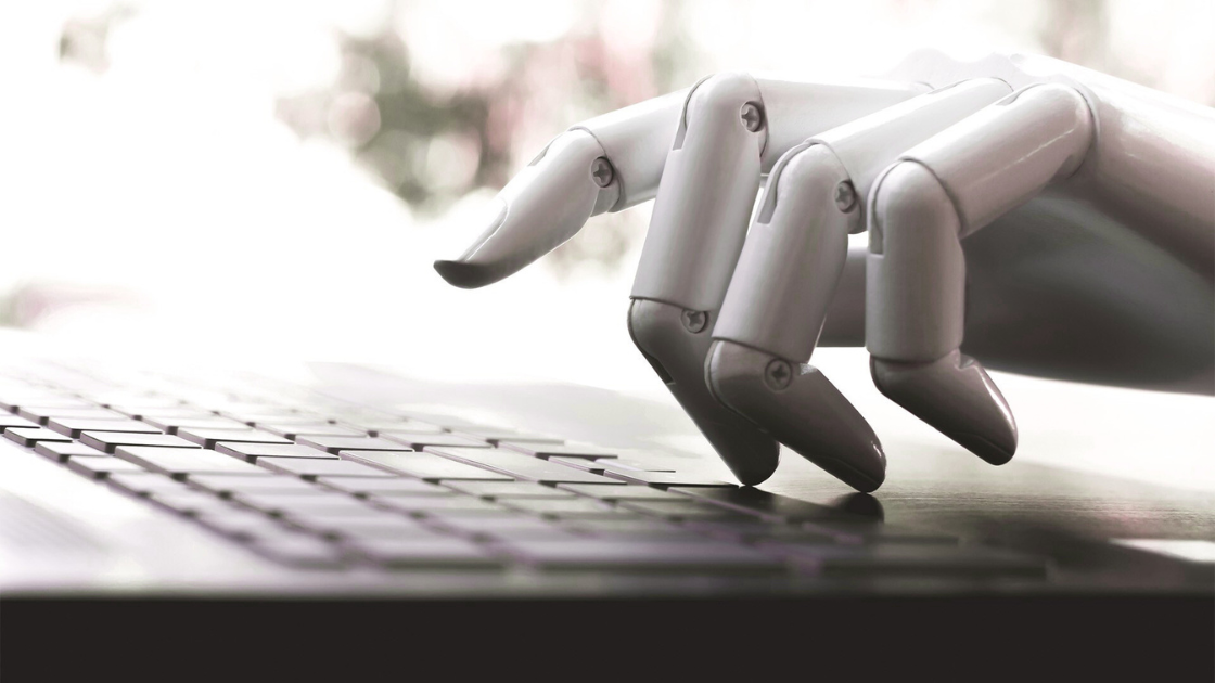 Robot typing on computer