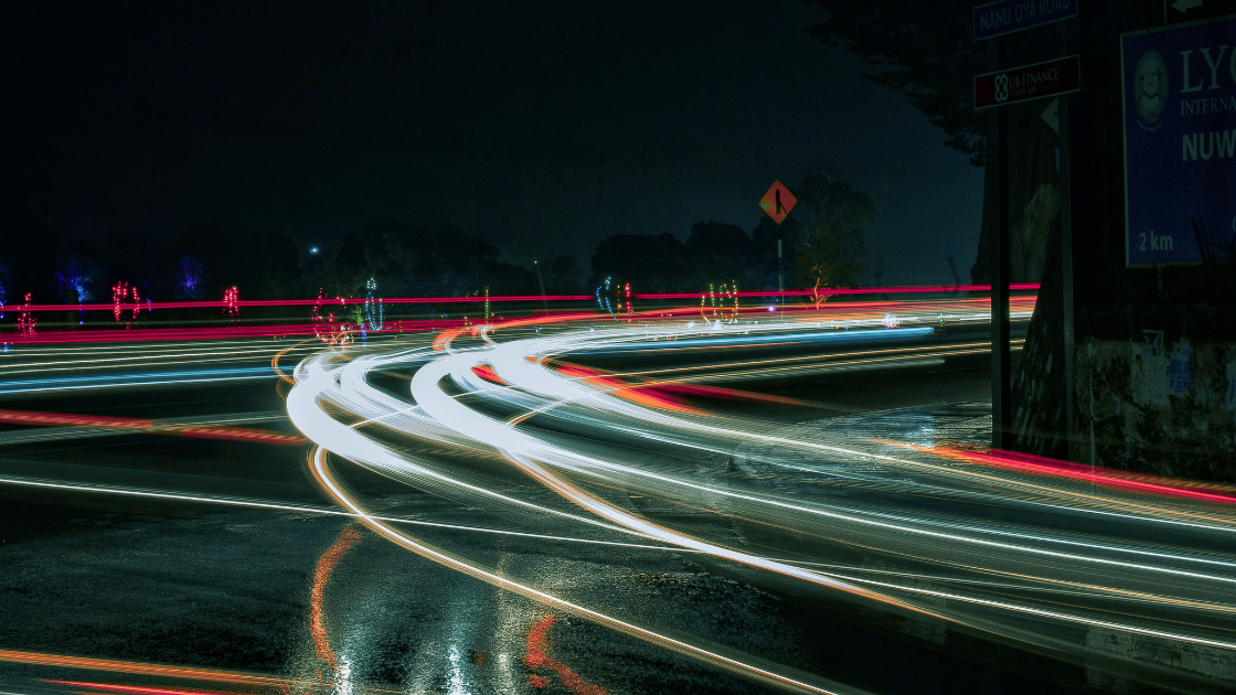 Long exposure of cars speeding around bend